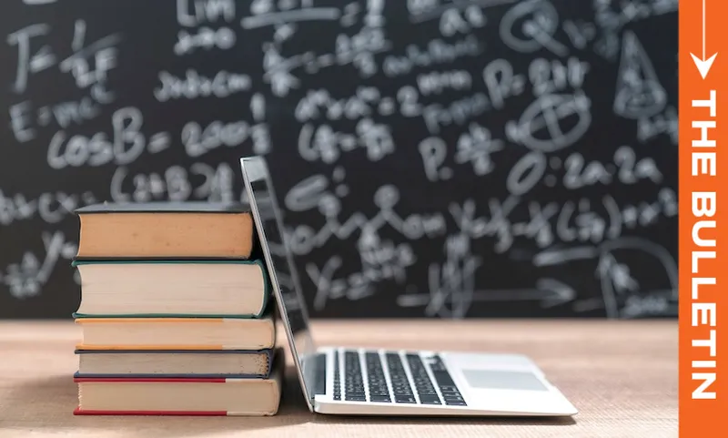 A stack of books and an open laptop sit on a desk in front of a chalkboard filled with math equations. An orange vertical banner on the right reads "THE BULLETIN.