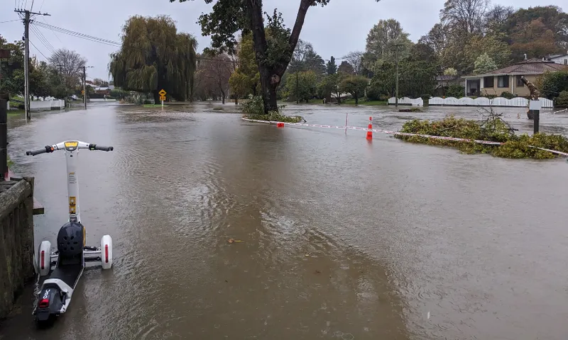 an escooter morosedly flooded with water covering a road in Beckenham on May 1