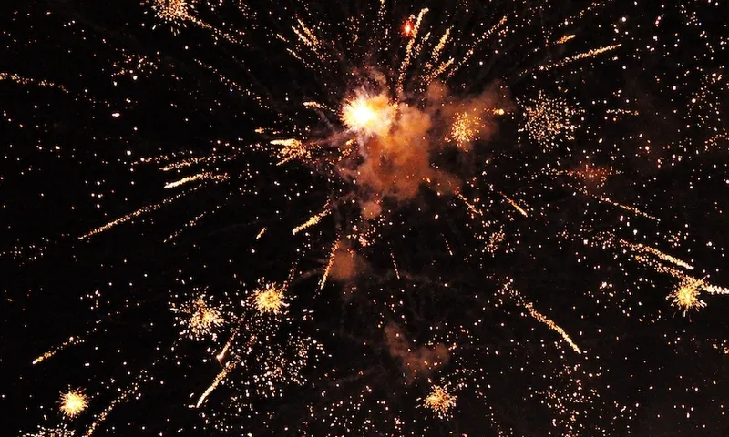 a black sky with fireworks exploding in the background