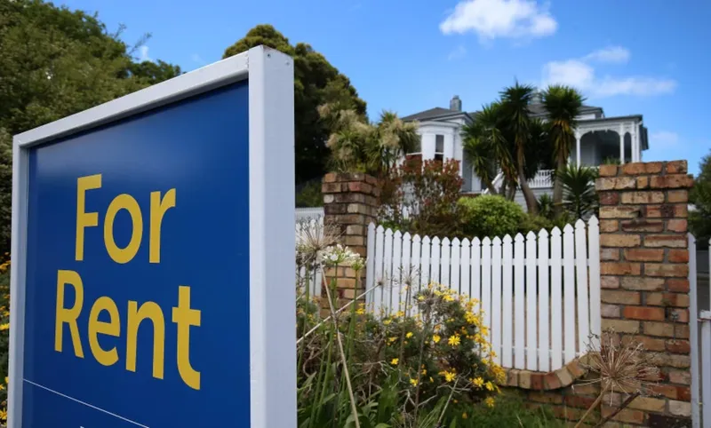 photo of a for rent sign in front of a house