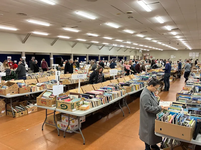 people browsing secondhand books on long tables