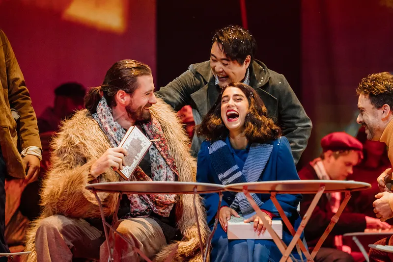 the cast of la boheme laughing on stage