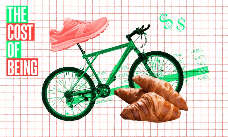 A collage with a grid background shows a green bicycle, a pink sneaker on the seat, two croissants in front, dollar signs, and a graph. Text on the left reads “THE COST OF BEING” in bold red and green letters.