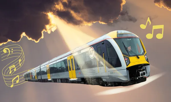 A modern yellow and silver train travels under dramatic, dark clouds with sun rays shining down; musical notes and a music staff float beside the train, giving a whimsical, uplifting feel.