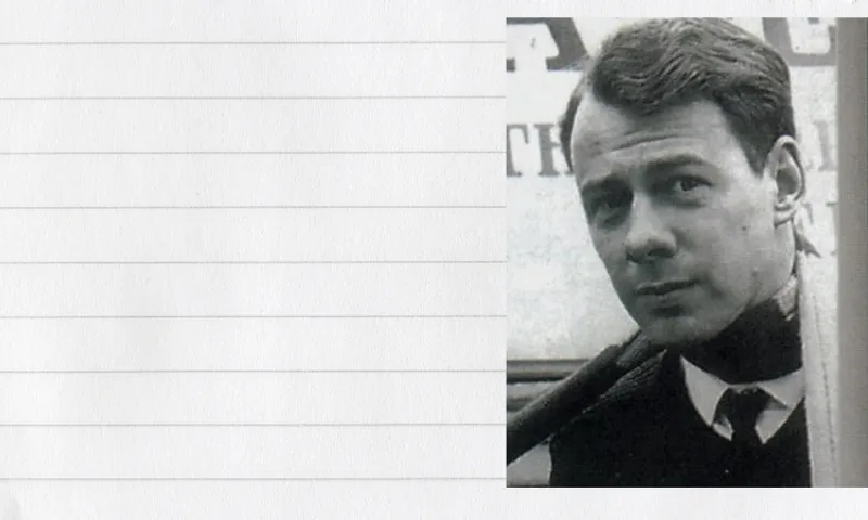 An old, black and white photo of a young man wearing a suit and tie