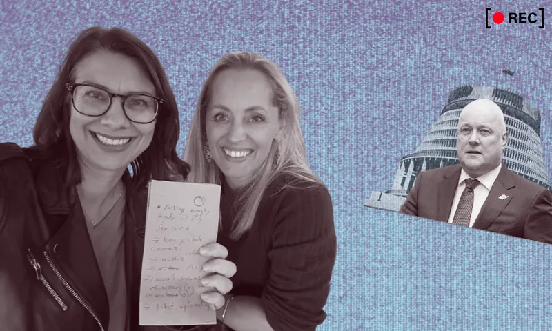 Two smiling women hold up a handwritten note in the foreground, while a suited man stands in front of New Zealand's Beehive building in the background, with a "REC" recording icon in the top right corner.