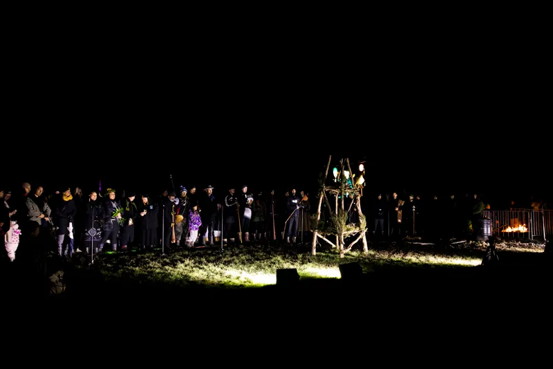 people gathered in darkness around a umu kohukohu whetū