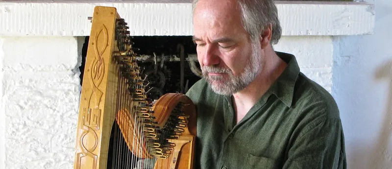 man playing a harp