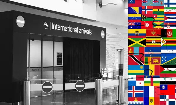 a black and white image showing black airport arrivals gate, with a colourful collection of country flags lined up to the right