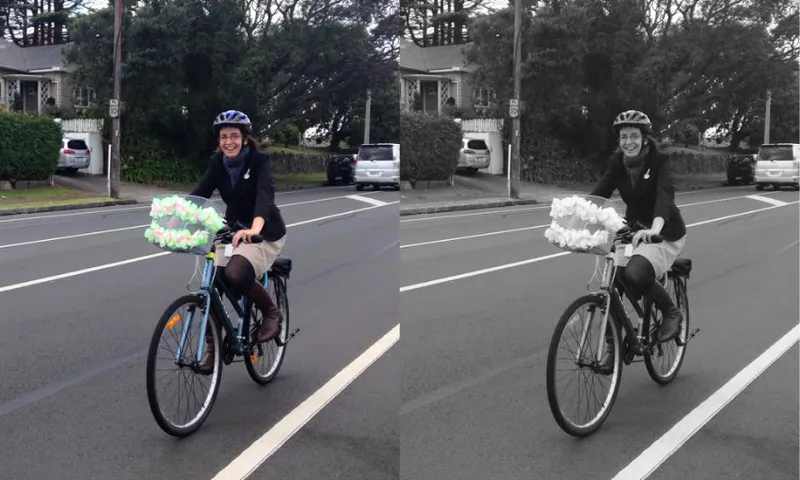 Two identical images of a woman in a dark coat and beige skirt cycling on an empty suburban street