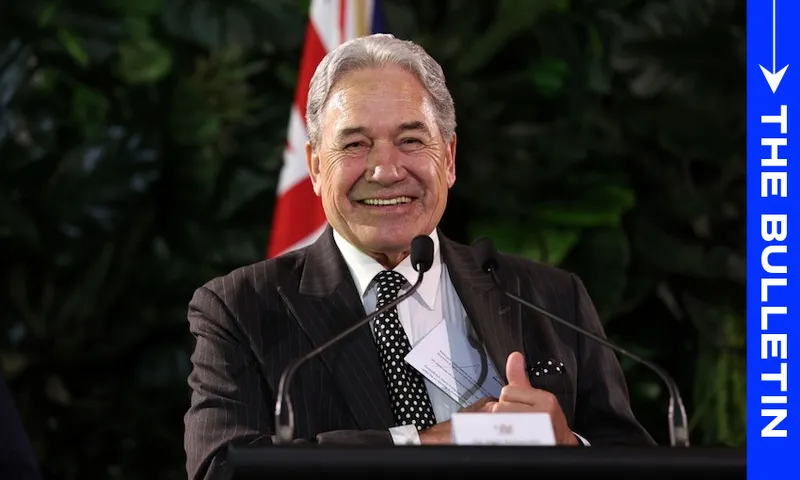 A smiling man in a dark suit stands at a podium with microphones, with a red and white flag and green foliage behind him. A vertical blue banner reads "THE BULLETIN" on the right side of the image.
