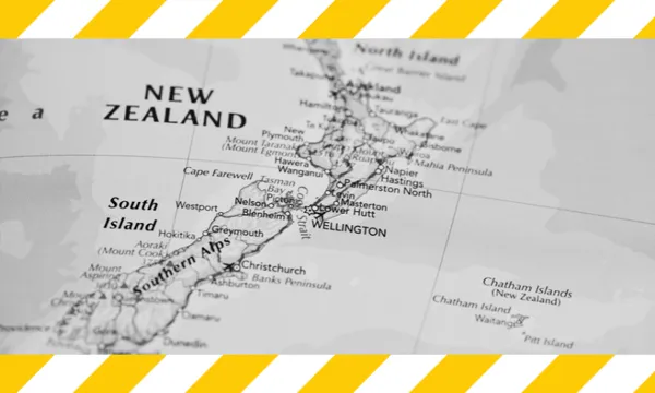Map of New Zealand in black and white with yellow and white tape across the top and bottom of the image