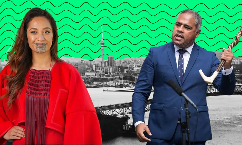 A woman in a red outfit with traditional moko kauae stands beside a man in a suit holding a tokotoko, with a city skyline and green patterned background behind them.