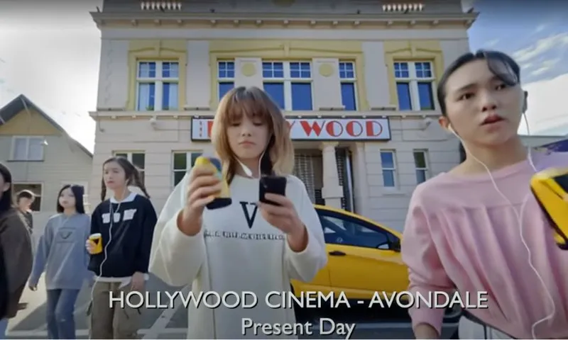 A screenshot from Hollywood Avondale PSA showing modern day Avondale with mostly young AI-generated Asian people.