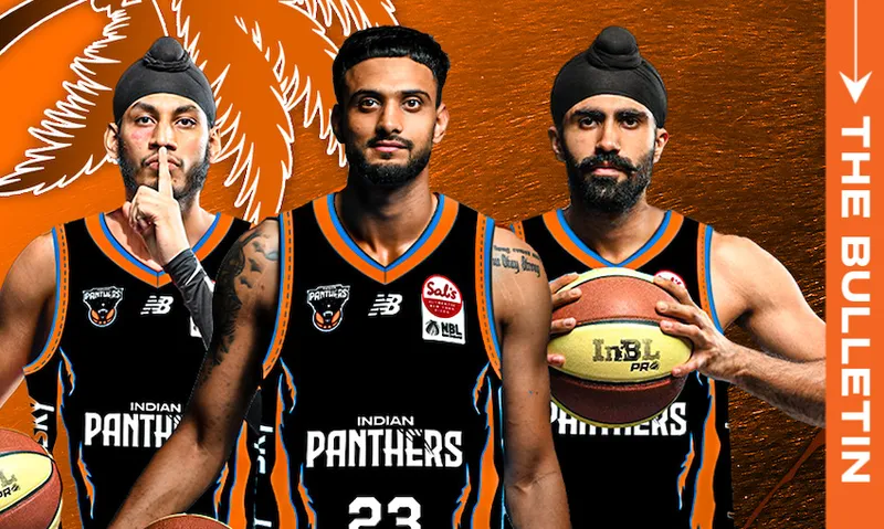 Three male basketball players wearing black Indian Panthers jerseys stand side by side against an orange background with a palm leaf design. One holds a basketball, while another makes a finger-to-lips gesture.