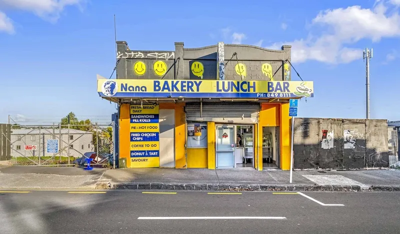 a yeallow and grey building with "Nana Bakery Lunch Bar" in blue writing along the top