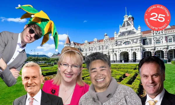 Five smiling adults, one wearing a colorful jester hat, stand in front of an ornate historic building with a manicured garden and blue sky.