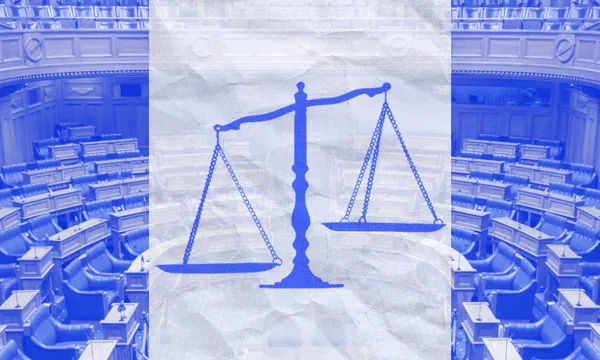 A blue-tinted illustration of balanced justice scales is superimposed over an image of an empty parliamentary chamber with rows of seats.