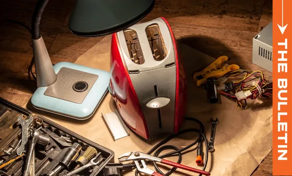 A red and silver toaster is disassembled on a workbench surrounded by tools, wires, a lamp, and a toolkit, with an orange sidebar on the right labeled "THE BULLETIN.
