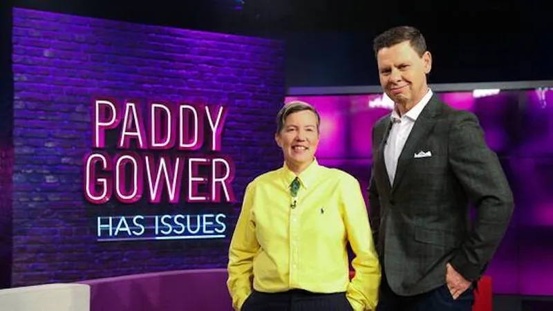 Karen O'Leary and Paddy Gower stand in a purple-lit TV studio in front of a neon sign that reads Paddy Gower Has Issues