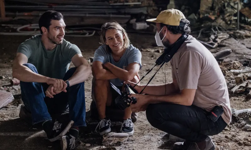 Actors Sophie Henderson and Matt Whelan sit on the crumbly floor of the St James Theatre while speaking to director Curtis Vowell.