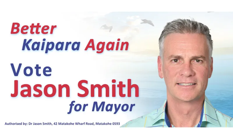 A campaign poster with the text “Better Kaipara Again. Vote Jason Smith for Mayor” next to a man in a blue checked shirt, with a seaside background and flying birds. The poster is authorized by Dr. Jason Smith.