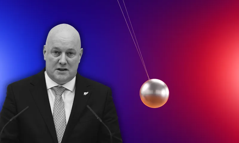 a man (the prime minister Chris Luxon) in a suit on a blue-to-red gradient backgroun with a silver pendulum ball swinging away from him