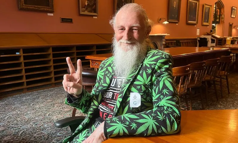 Gary Chiles throws up a peace sign in the parliament library.