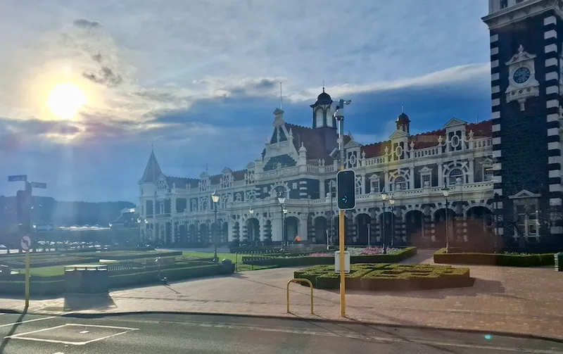 A shot of Dunedin's historic railway station, with gardens in front of it