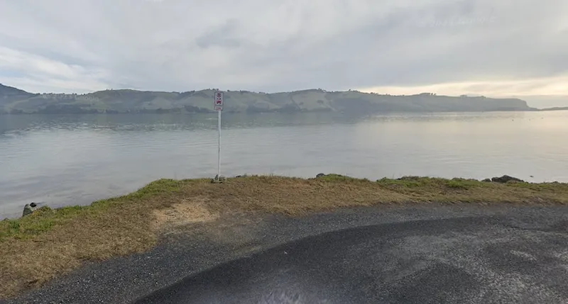 A Google Maps screenshot of a Bus Stop sign beside the sea