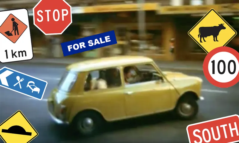 The car from New Zealand movie Goodbye Pork Pie surrounded by road signs