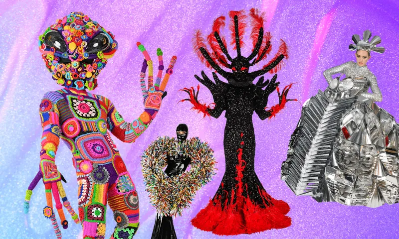 Four people wear extravagant, futuristic costumes: a rainbow crochet alien, a figure in a black sparkling heart with fringe, a black and red gown with large spiky headpiece, and a metallic silver sculptural dress. Sparkly purple background.