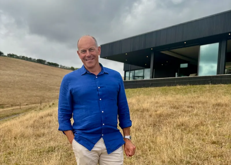 Phil Spencer stands in front of a house featuring in NZ's Best Homes