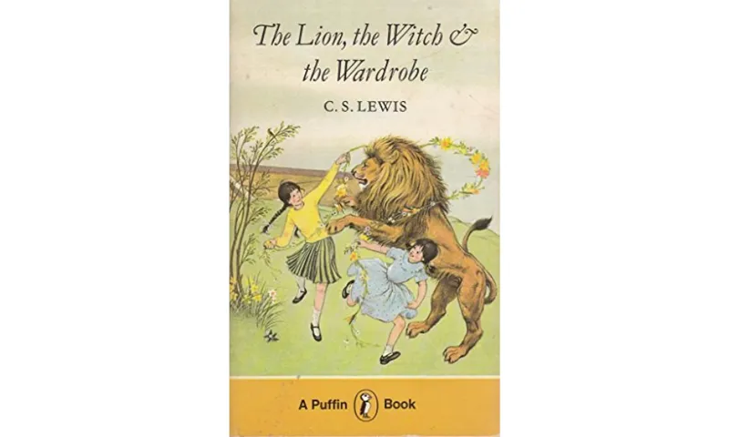 The cover of The Lion, the Witch and the Wardrobe from Puffin 1979. It shows an illustration of two girls dancing around a lion.
