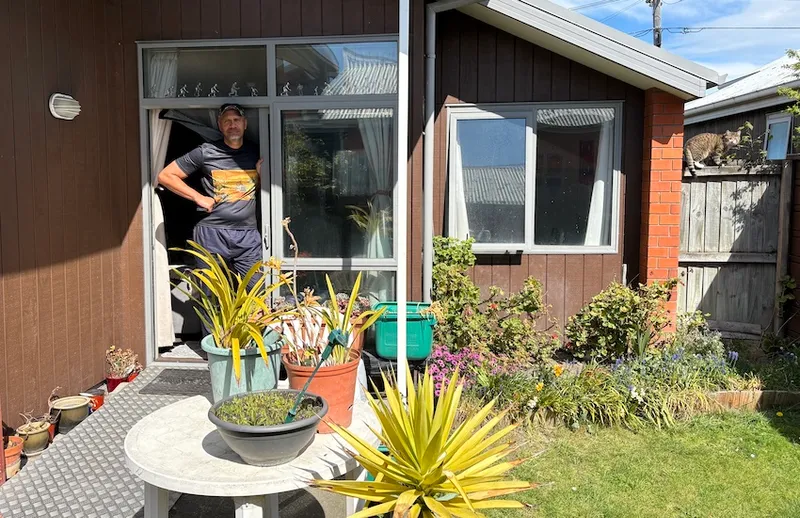 Rob stands in the garden at the back of the property
