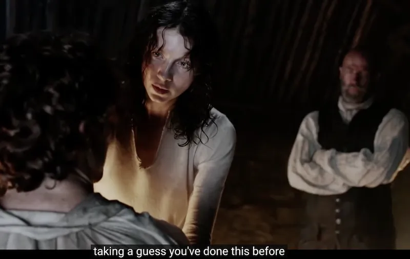 A screenshot from Outlander of Claire meeting Jamie for the first time, with the closed caption saying "I'm a nurse"