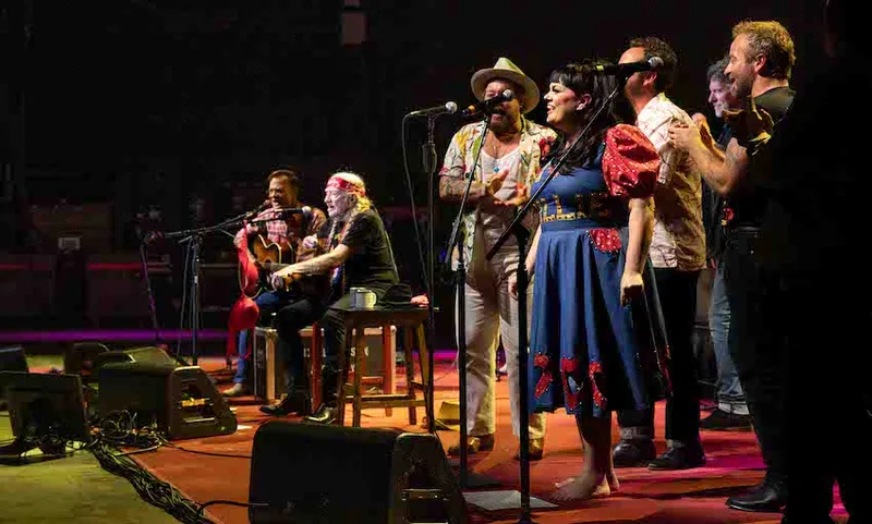 A large concert stage featuring Willie Nelson and Tami Neilson during the Outlaw tour