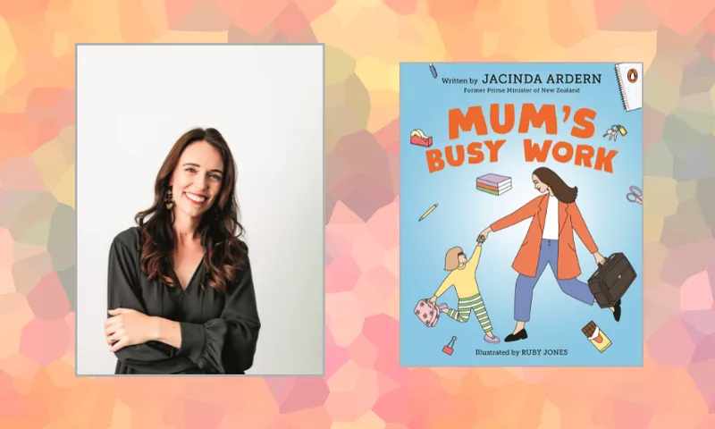 A woman with long dark hair wearing a black blouse smiles with arms crossed next to the cover of a children’s book titled “Mum’s Busy Work,” showing a woman holding a child’s hand while carrying a briefcase.