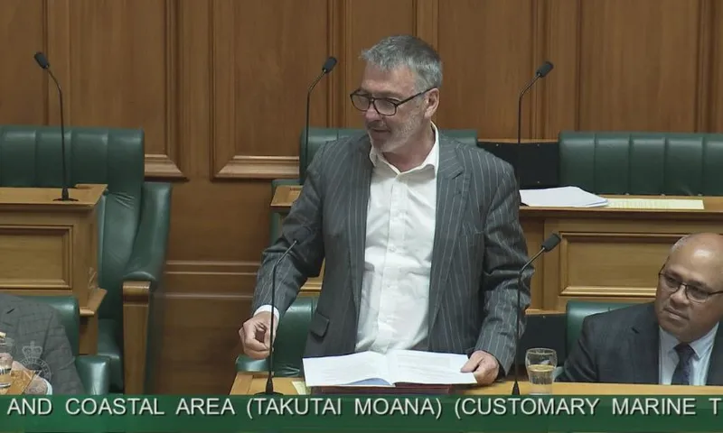 Wearing a grey suit, Labour MP Duncan Webb speaks to the House from his bench.