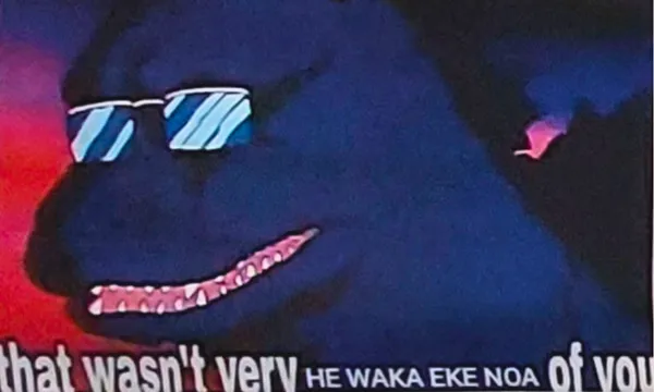 A dark, cartoonish dinosaur wearing sunglasses grins widely against a red and purple background. White subtitle text partially reads, “that wasn’t very HE WAKA EKE NOA of you.”.