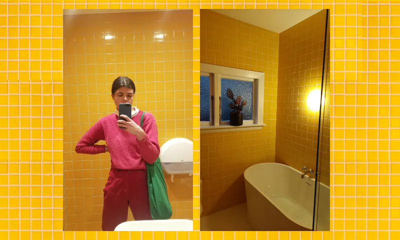 A yellow tiled backdrop with two photo insets – one of a woman dressed in pink and red against a yellow background and one of a yellow tiled personal bathroom