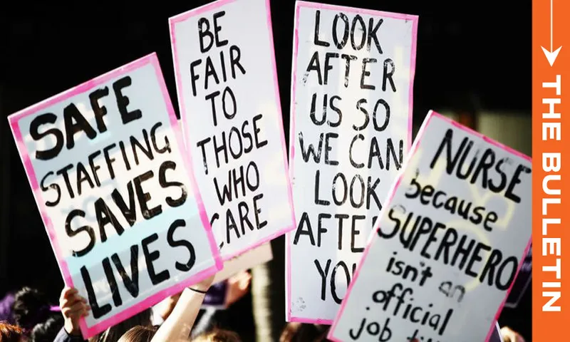 A group of people hold protest signs about healthcare, reading “SAFE STAFFING SAVES LIVES,” “BE FAIR TO THOSE WHO CARE,” “LOOK AFTER US SO WE CAN LOOK AFTER YOU,” and “NURSE because SUPERHERO isn’t an official job title.”.