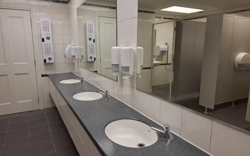 The mirrors and sinks inside the Municipal Lane restroom toilets