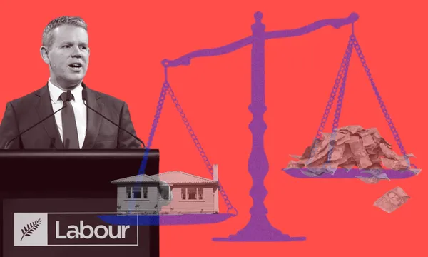 Chris Hipkins speaks at a podium with a Labour sign on it. To his right is a scales symbol, with a house on one side and a pile of cash on the other. The background to the whole image is red.