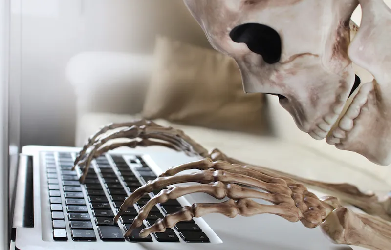 Skeleton typing on laptop