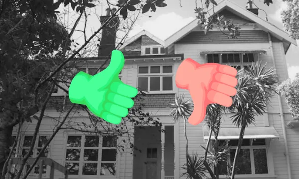 A black and white photo of a large house with trees around it, with a thumbs up and down emoji overlaid.