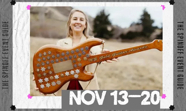 A photo of a woman holding out a guitar adorned with gold and silver stars.
