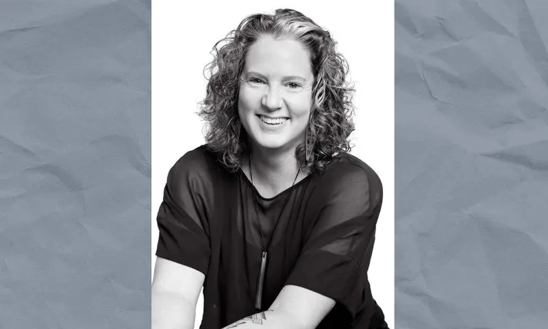 A black and white image of a woman on a grey background