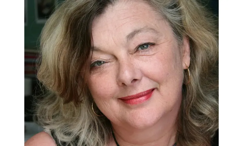 A close up of a face of a woman who is smiling.