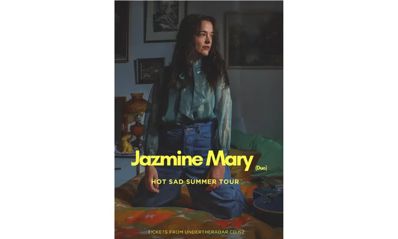 A poster for Jazmine Mary the musician showing the musician kneeling looking to the side.